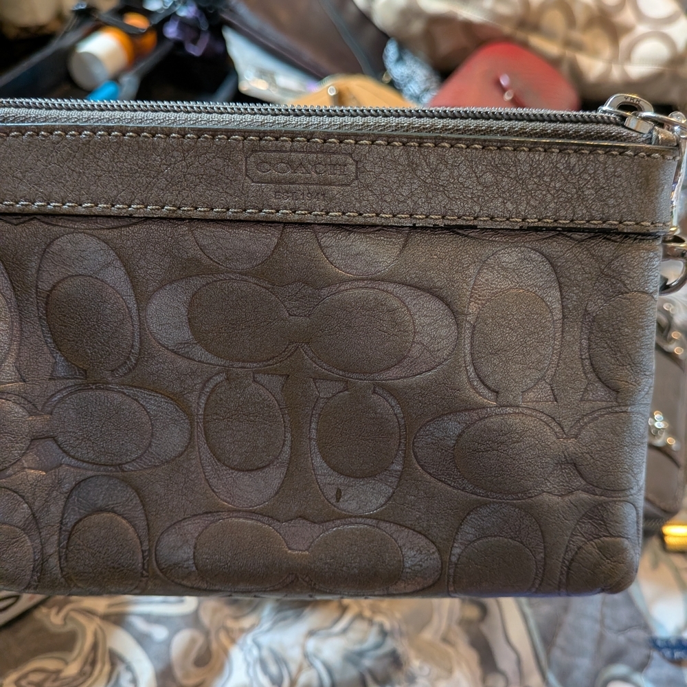 Coach metallic leather wristlet featuring the brand's signature "C" monogram